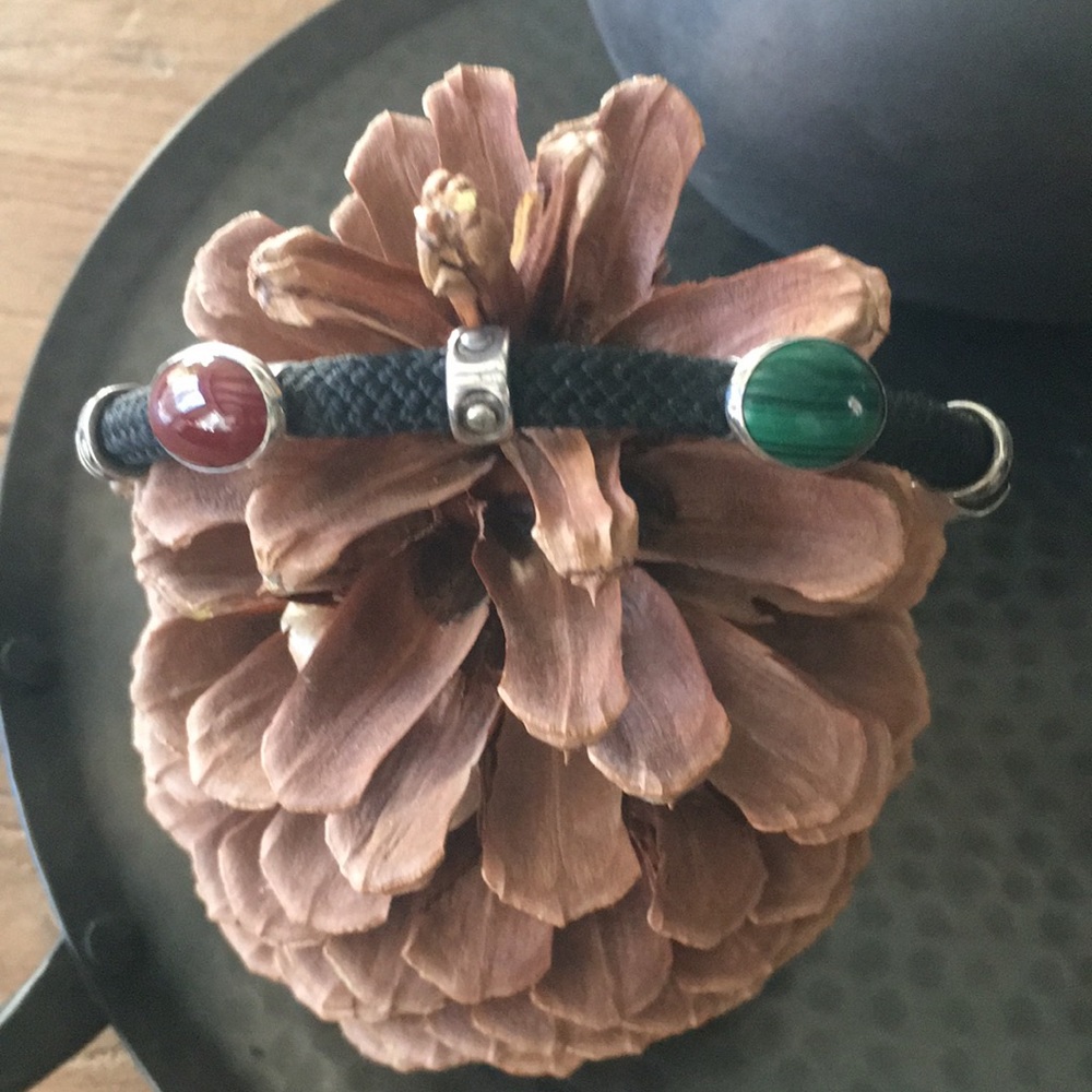 Malachite and carnelian stones with silver accents/clasp on black woven bracelet